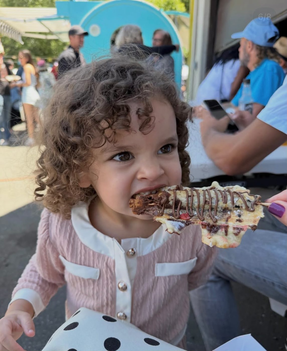 Young guest enjoying a crepe on a stick
