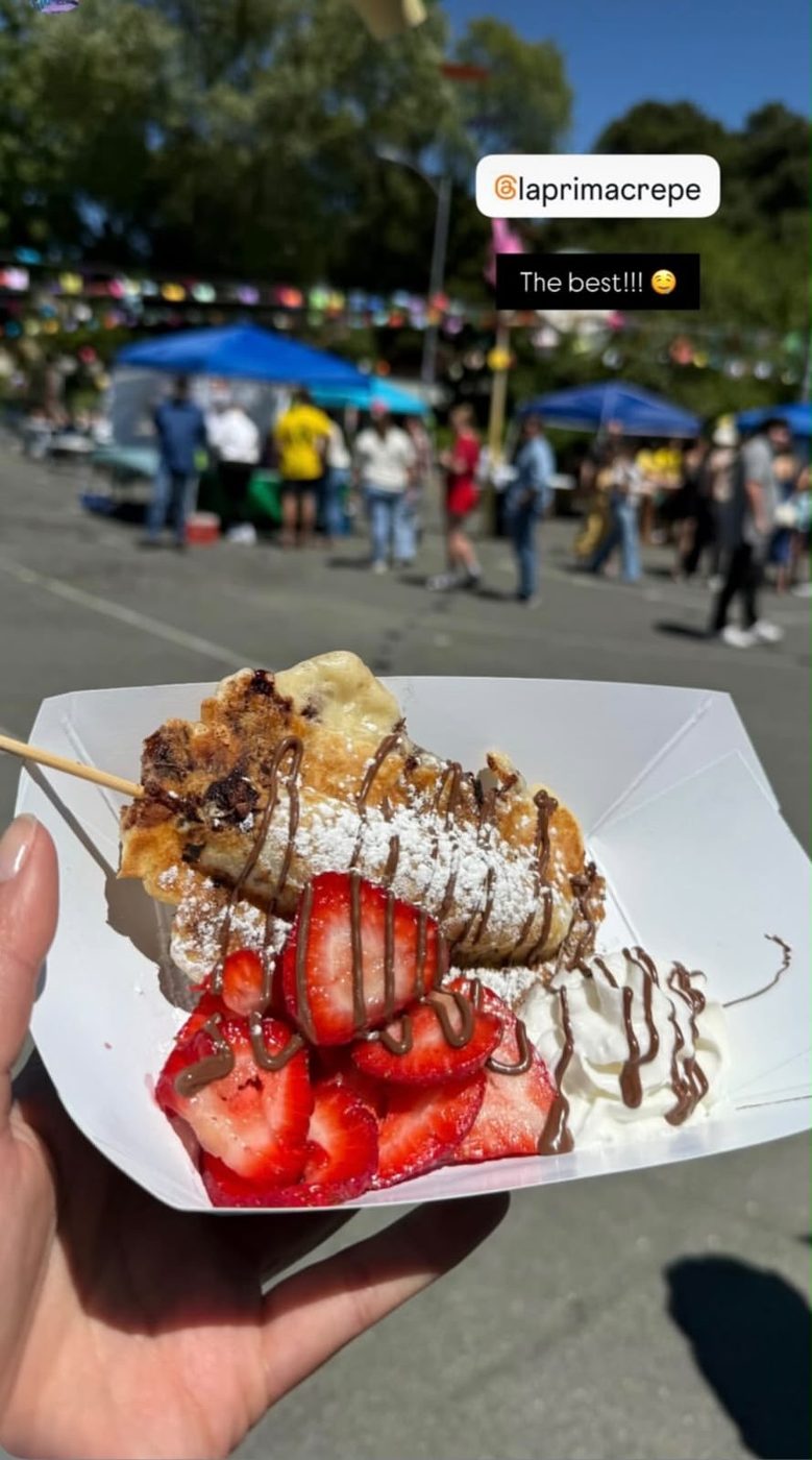 A fresh strawberry-chocolate crepe in hand